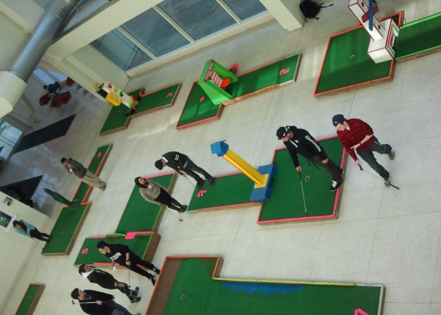 Students playing mini-golf on the concourse
